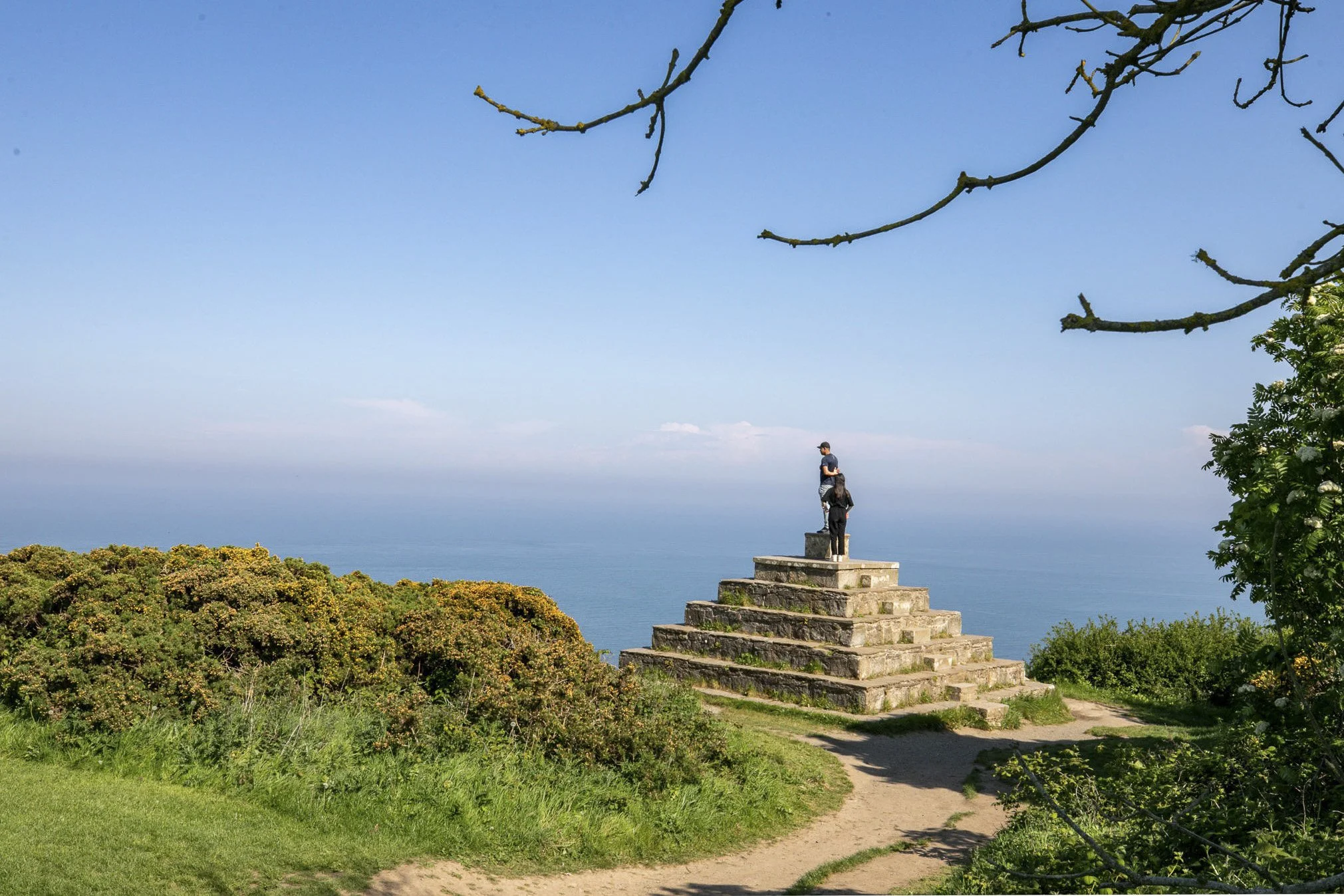 Coastal walking path and viewpoint near a residential area